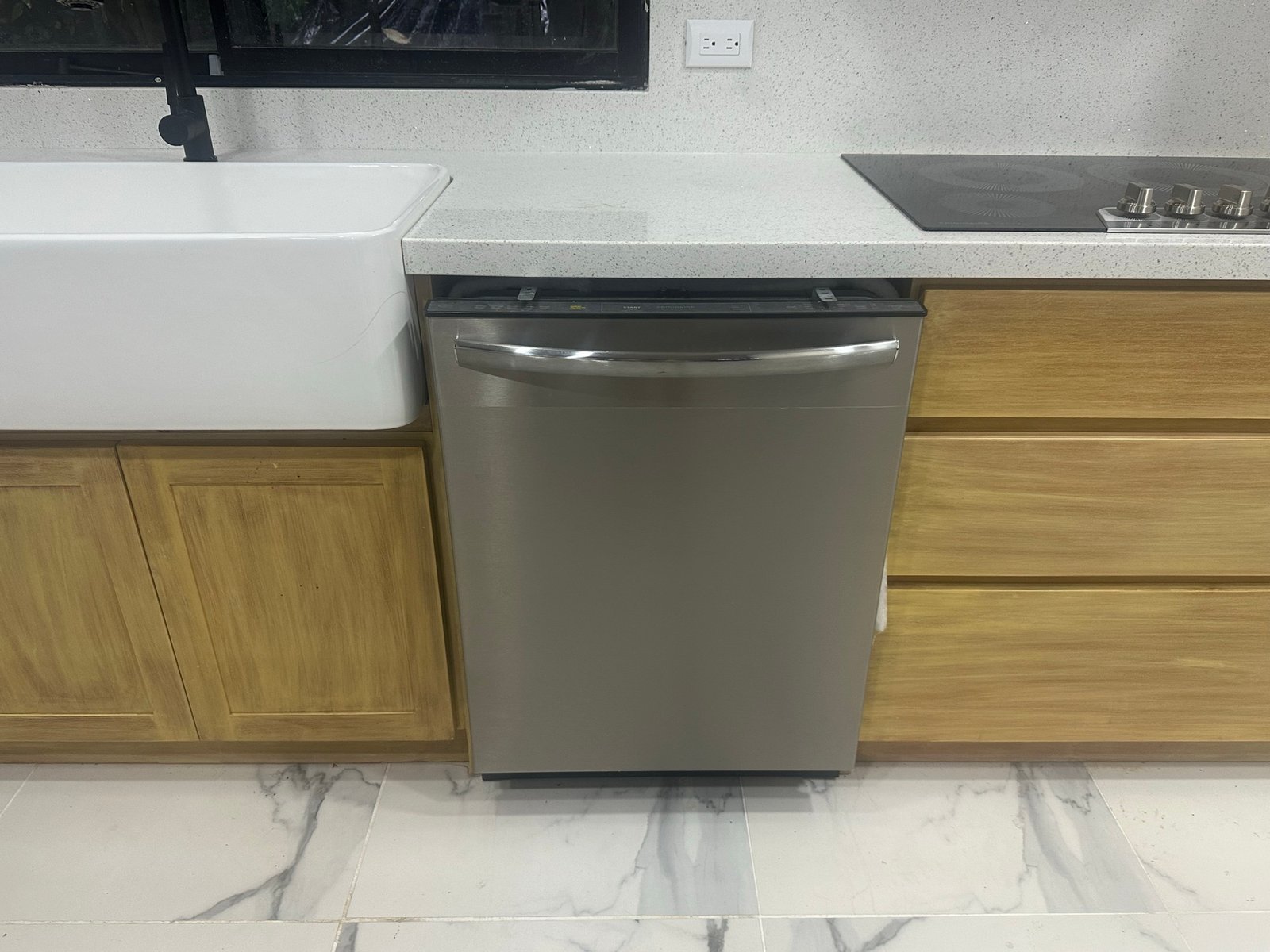 Stainless dishwasher installed beneath the counter