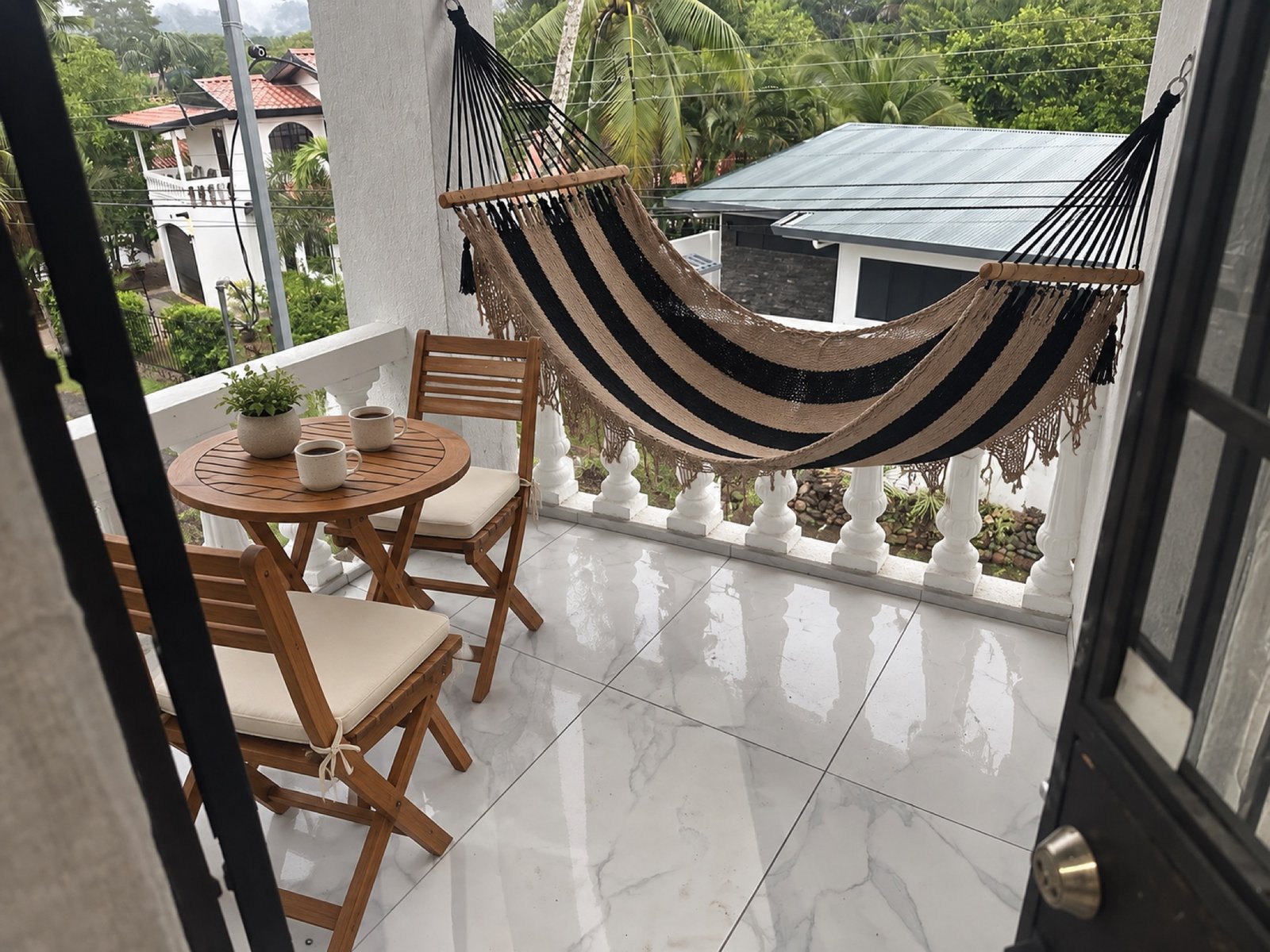 Covered terrace with hammock and garden view