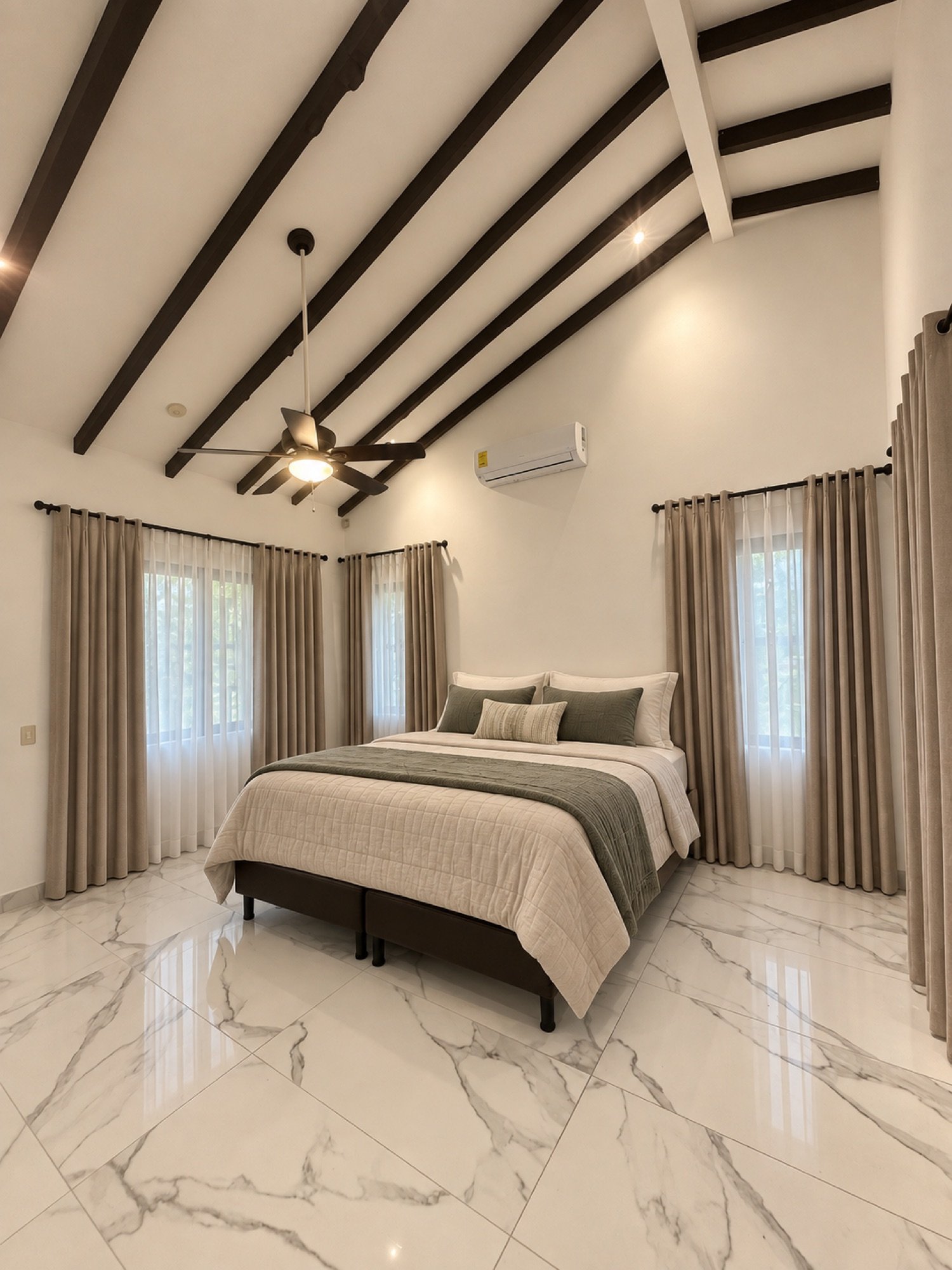 Primary bedroom with vaulted beamed ceiling and marble-look tile