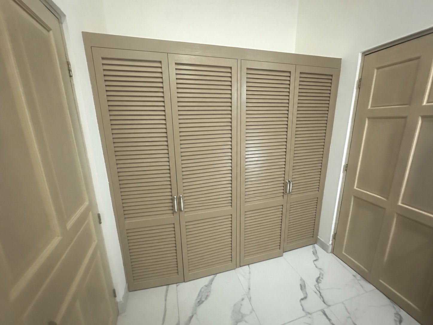 Built-in louvered closet doors in the primary suite
