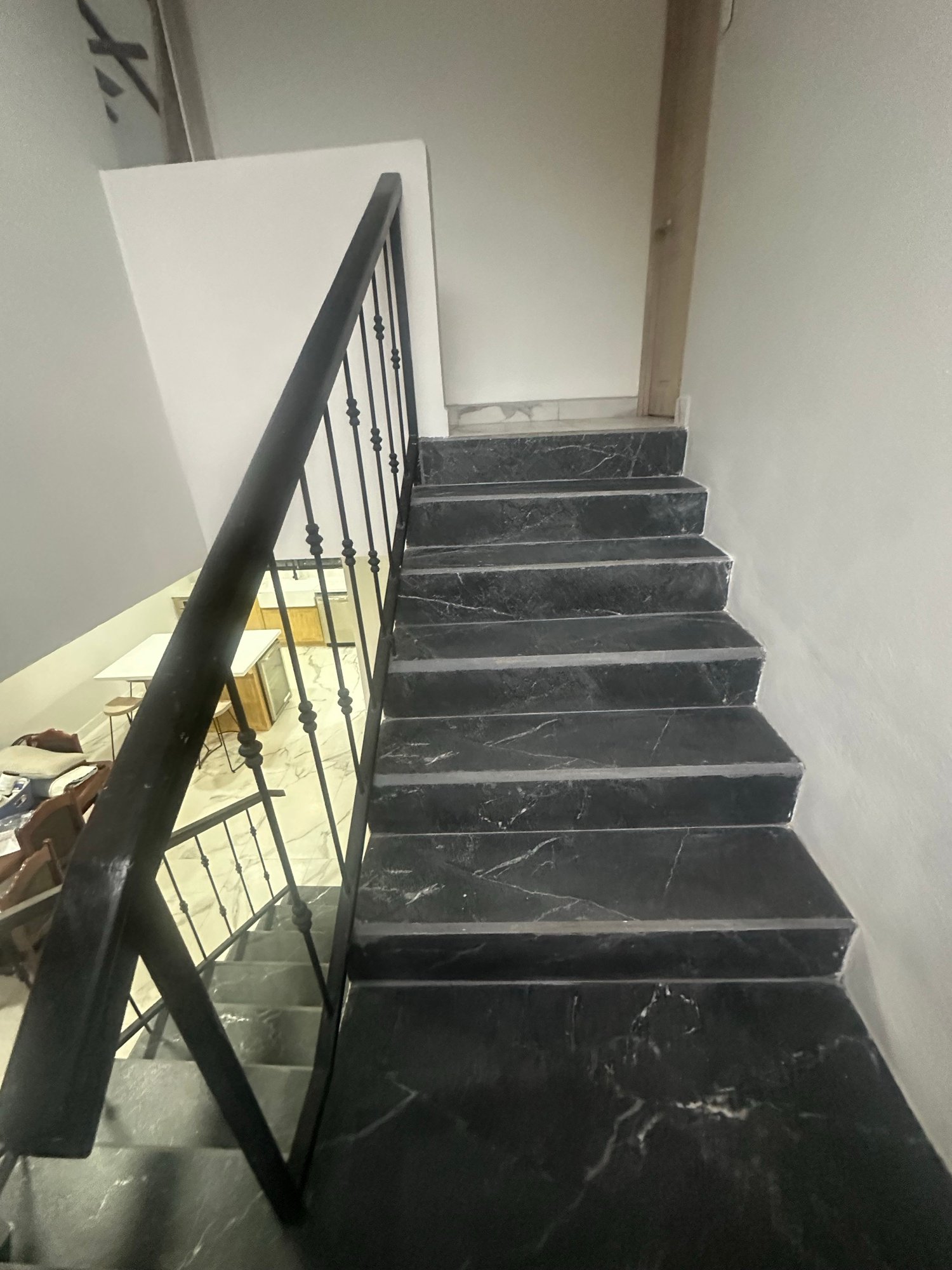 Staircase with dark treads and black metal railing
