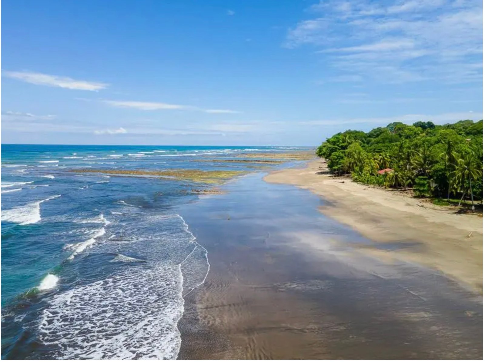 Wide sandy beach and tropical shoreline in the Esterillos area